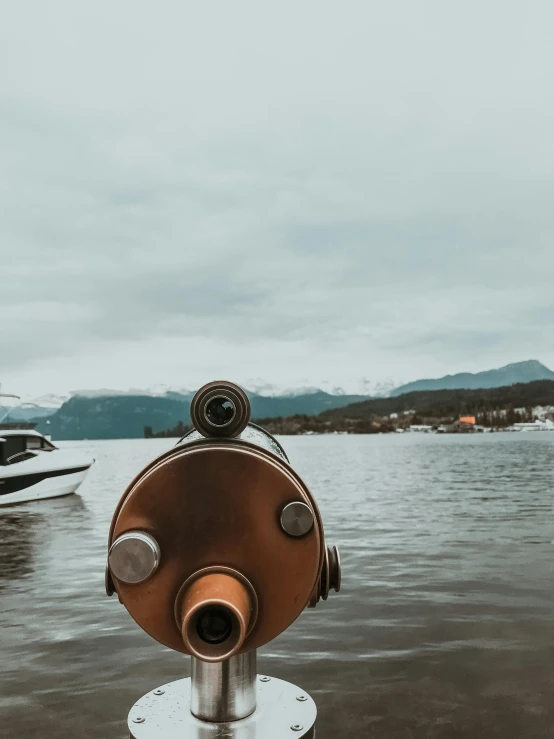 a telescope sitting on top of a metal pole next to a body of water, by Johannes Voss, pexels contest winner, visual art, taken on a ww 2 camera, on a boat on a lake, today\'s featured photograph 4k, first person view