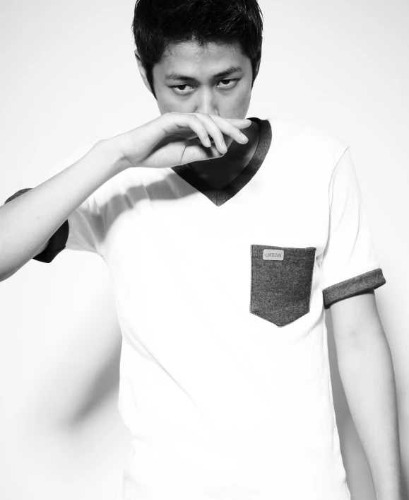 a black and white photo of a man smoking a cigarette, inspired by Gang Hui-an, unsplash, shin hanga, tshirt!!, studio photoshoot, dressed in a white t-shirt, polaroide photo