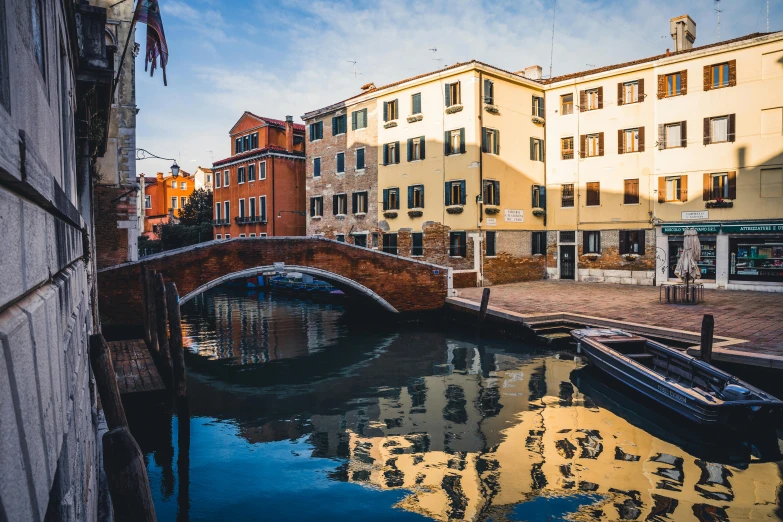 a bridge over a canal with buildings in the background, inspired by Quirizio di Giovanni da Murano, pexels contest winner, golden morning light, thumbnail, lagoon, group photo