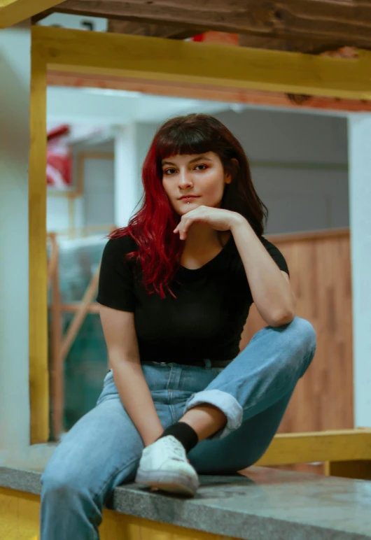 a woman with red hair sitting on a ledge, inspired by Elsa Bleda, trending on pexels, realism, center parted bangs, standing in corner of room, yael shelbia, avatar image