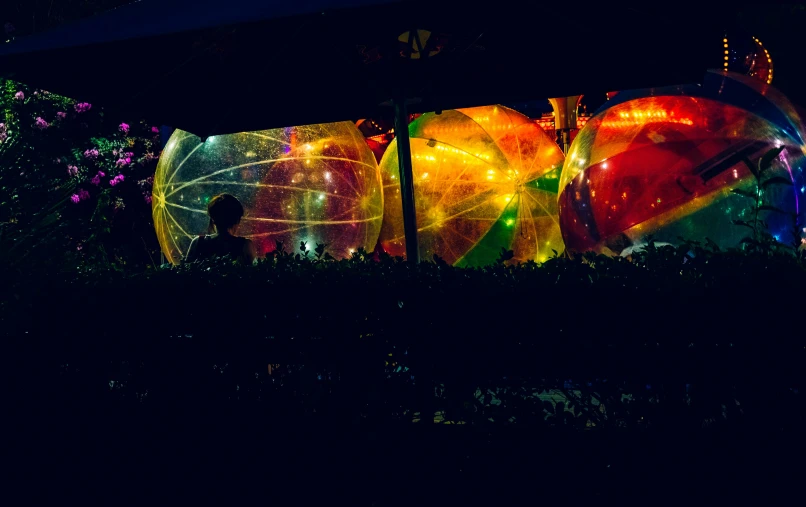 a couple of people that are inside of an inflatable ball, inspired by Bruce Munro, unsplash, interactive art, panoramic shot, lanterns, an outdoor festival stage, mid shot photo