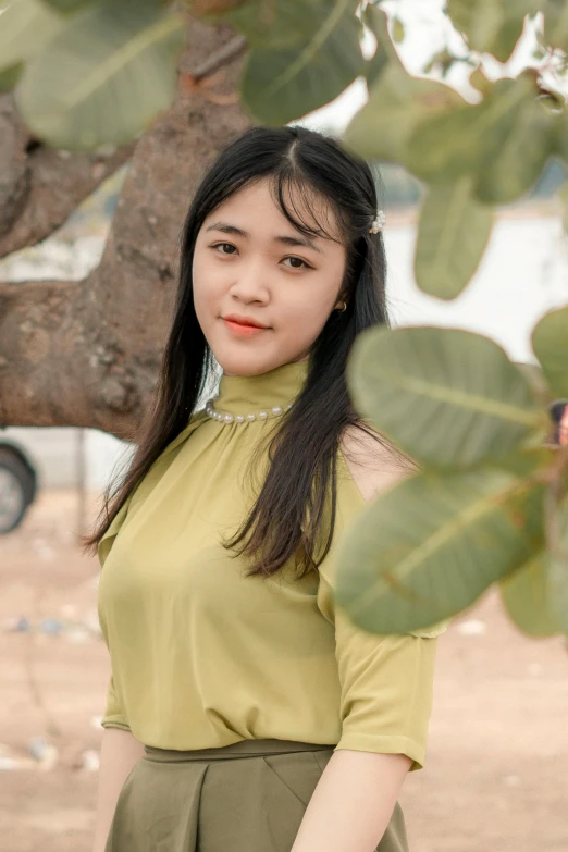 a woman standing in front of a tree, a picture, inspired by Ruth Jên, pexels contest winner, realism, young cute wan asian face, square, low quality photo, teenager girl