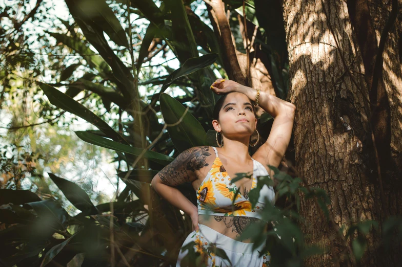 a woman standing next to a tree in a forest, a photo, body covered in floral tattoos, 8k 50mm iso 10, beautiful tan mexican woman, avatar image