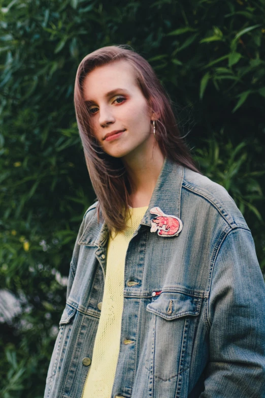 a woman in a denim jacket poses for a picture, an album cover, inspired by Elsa Bleda, trending on pexels, 🤤 girl portrait, brightly colored, mew, portra