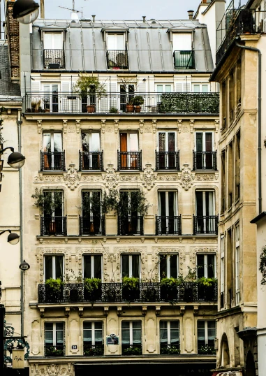 a group of people walking down a street next to tall buildings, trending on unsplash, paris school, photo of a beautiful window, plants on balconies, wrought iron architecture, square