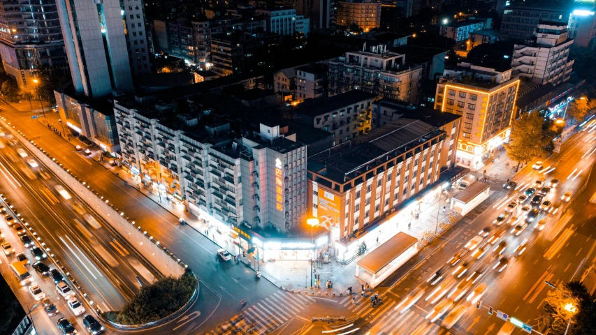 an aerial view of a city at night, an album cover, pexels contest winner, chinese building, thumbnail, warm street lights store front, drone footage