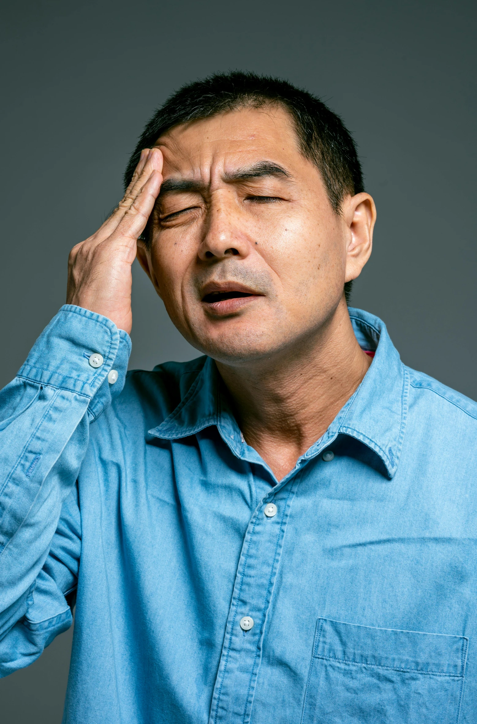a man holding his head in his hands, a stock photo, inspired by Zhang Xiaogang, pexels, shin hanga, studio portrait, annoyed facial expression, ernie chan, movie still of a tired