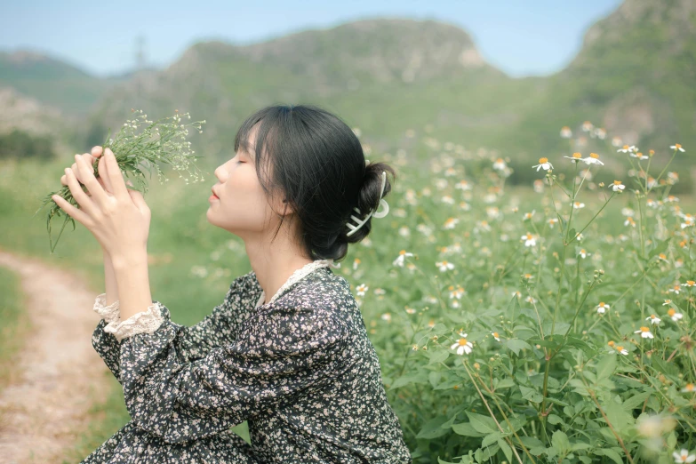 a woman sitting in a field holding a flower, inspired by Ma Yuanyu, unsplash, hong soonsang, profile image, cai xukun, 4k)