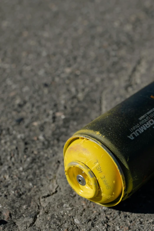 a yellow and black spray can sitting on the ground, a picture, unsplash, pbr material, background image, ((rust)), superfine ink detail