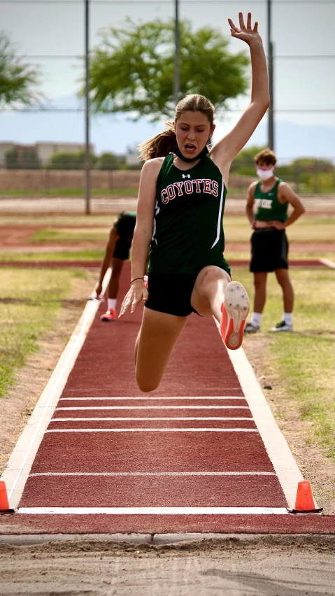 a girl jumping a long jump on a track, by Carey Morris, low quality photo, lorena avarez, digital image, thumbnail