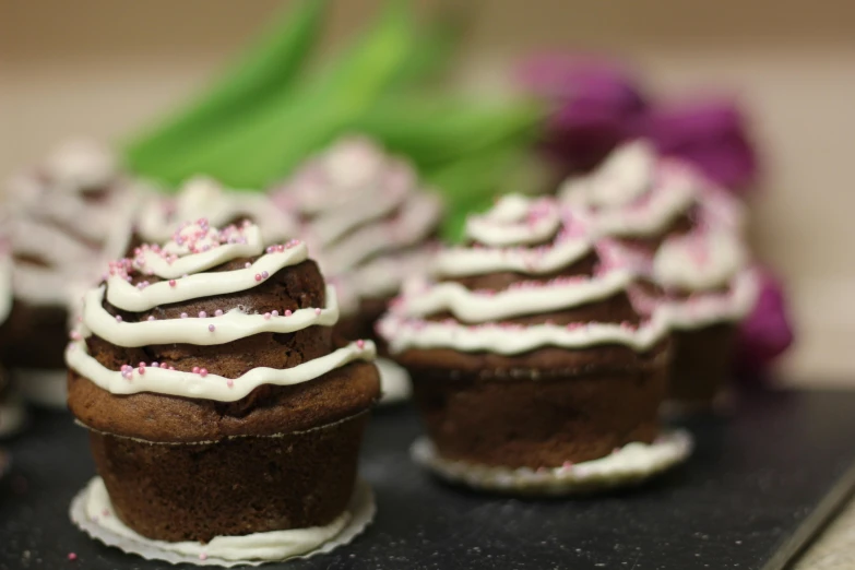 a bunch of cupcakes with white frosting and pink sprinkles, pixabay, renaissance, chocolate frosting, background image, 3d with depth of field, thumbnail