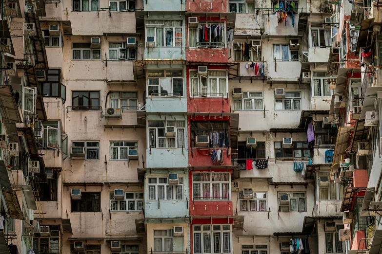 a very tall building with lots of windows, by Benjamin Block, unsplash contest winner, hyperrealism, shanty town, crenellated balconies, kakar cheung, faded colours