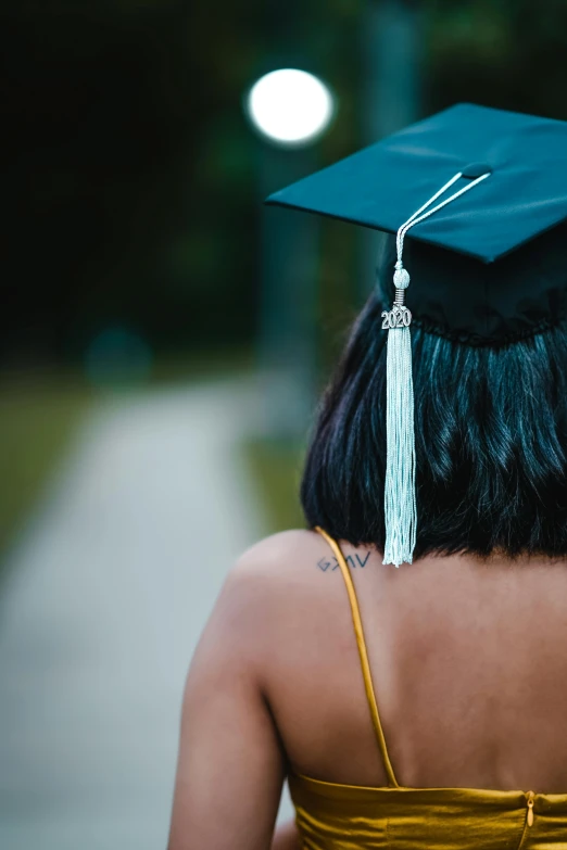 a woman wearing a graduation cap and gown, by Carey Morris, pexels, square, multiple stories, trending on, words