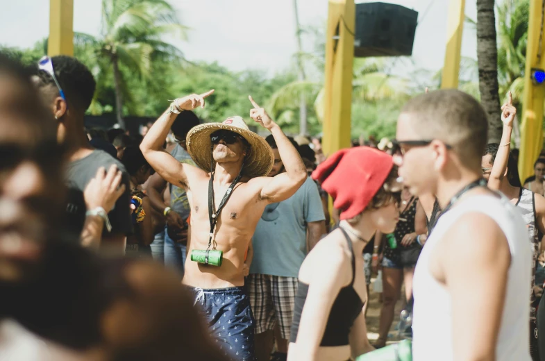 a man in a straw hat standing in front of a crowd of people, a photo, trending on unsplash, happening, beach party, jamaica, avatar image