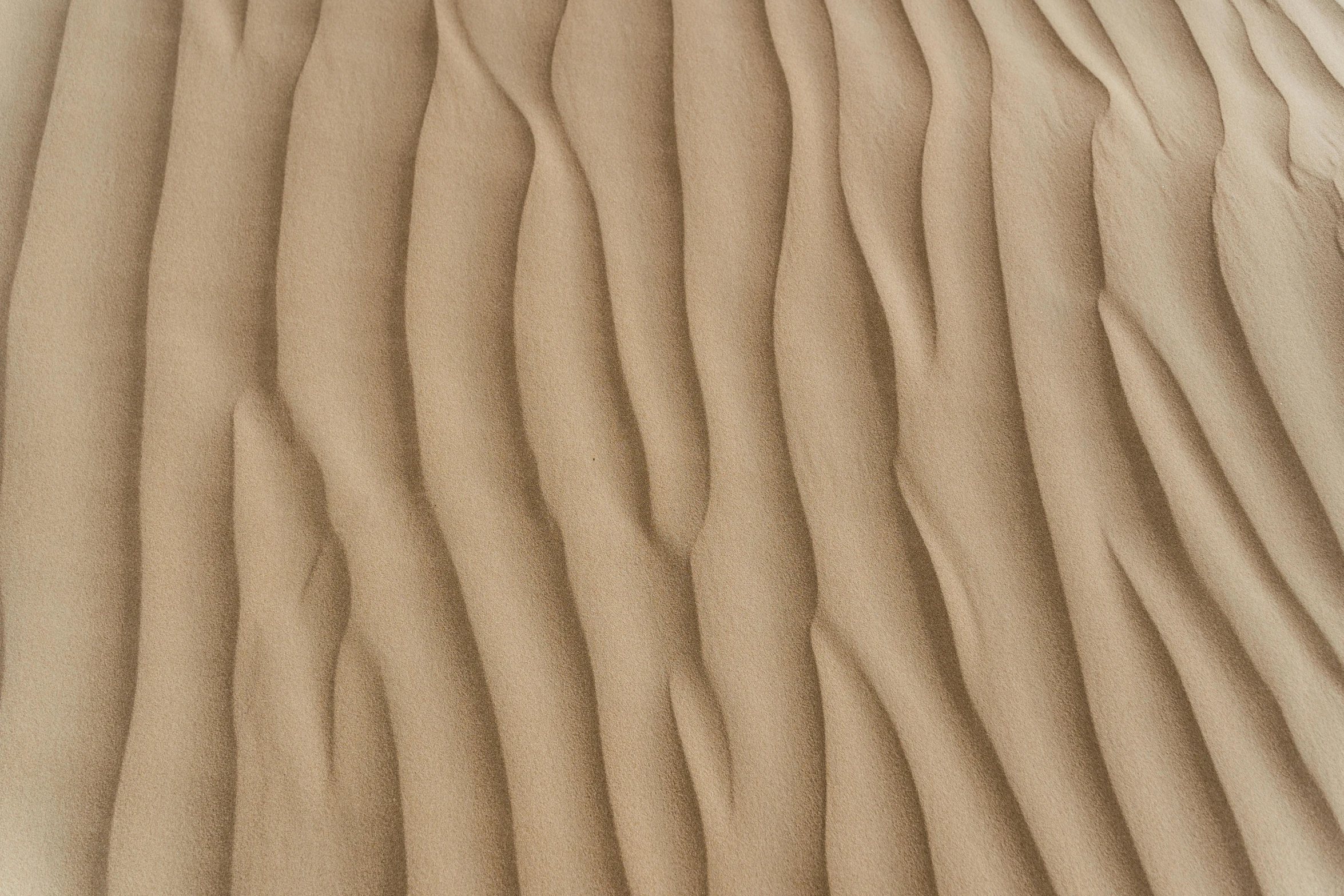 a close up of a sand dune in the desert, inspired by Edward Weston, trending on pexels, op art, taupe, linen, carved wood, flowing realistic fabric