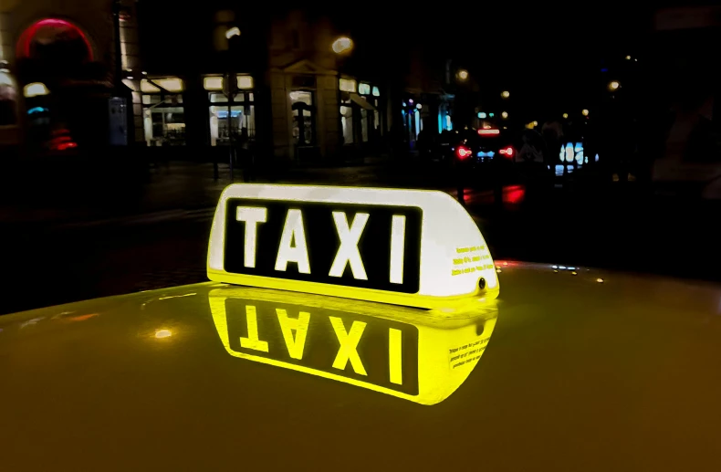 a taxi sign sitting on top of a yellow car, reflective lighting, square, thumbnail, commercial lighting
