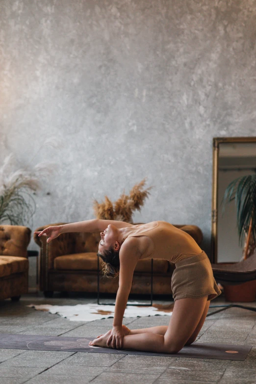 a woman doing a yoga pose in a living room, by Anna Boch, unsplash, renaissance, texture, masculine pose, ochre, back arched