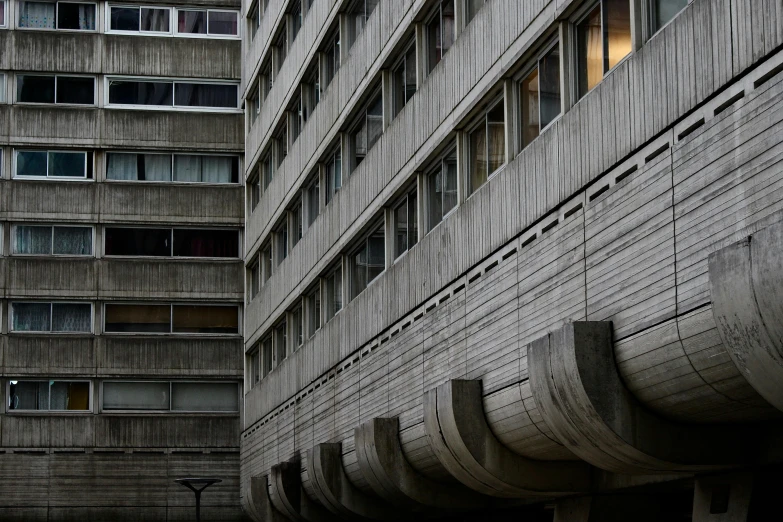 a couple of tall buildings next to each other, a photo, unsplash, brutalism, crenellated balconies, government archive photograph, grey, slide show
