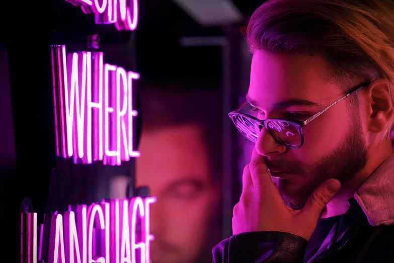 a man talking on a cell phone in front of a neon sign, trending on pexels, art & language, singer maluma, pink glasses, purple scene lighting, pondering