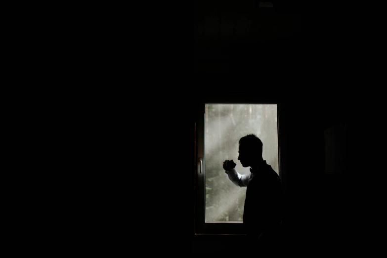 a man standing in front of a window in the dark, a picture, hurufiyya, boxing, morning hour, profile image, reuters