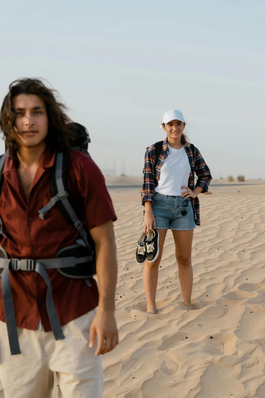 a couple of people walking on top of a sandy beach, tanned ameera al taweel, wearing adventuring gear, teenagers, max dennison