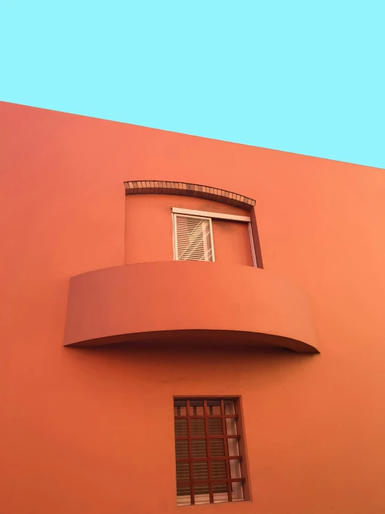 a red building with a window and a balcony, inspired by Ricardo Bofill, pexels contest winner, neo-fauvism, teal orange, rounded roof, low quality photo, chile