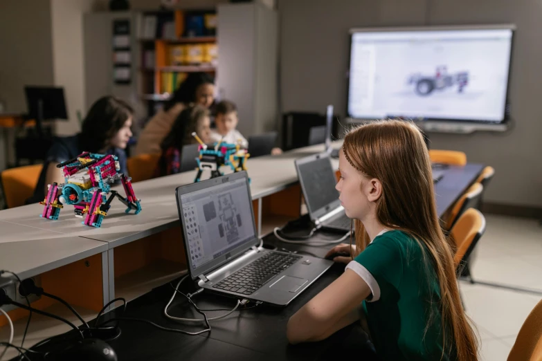 a girl sitting in front of a laptop computer, a computer rendering, pexels contest winner, legos, in a classroom, boston dynamics robots, avatar image