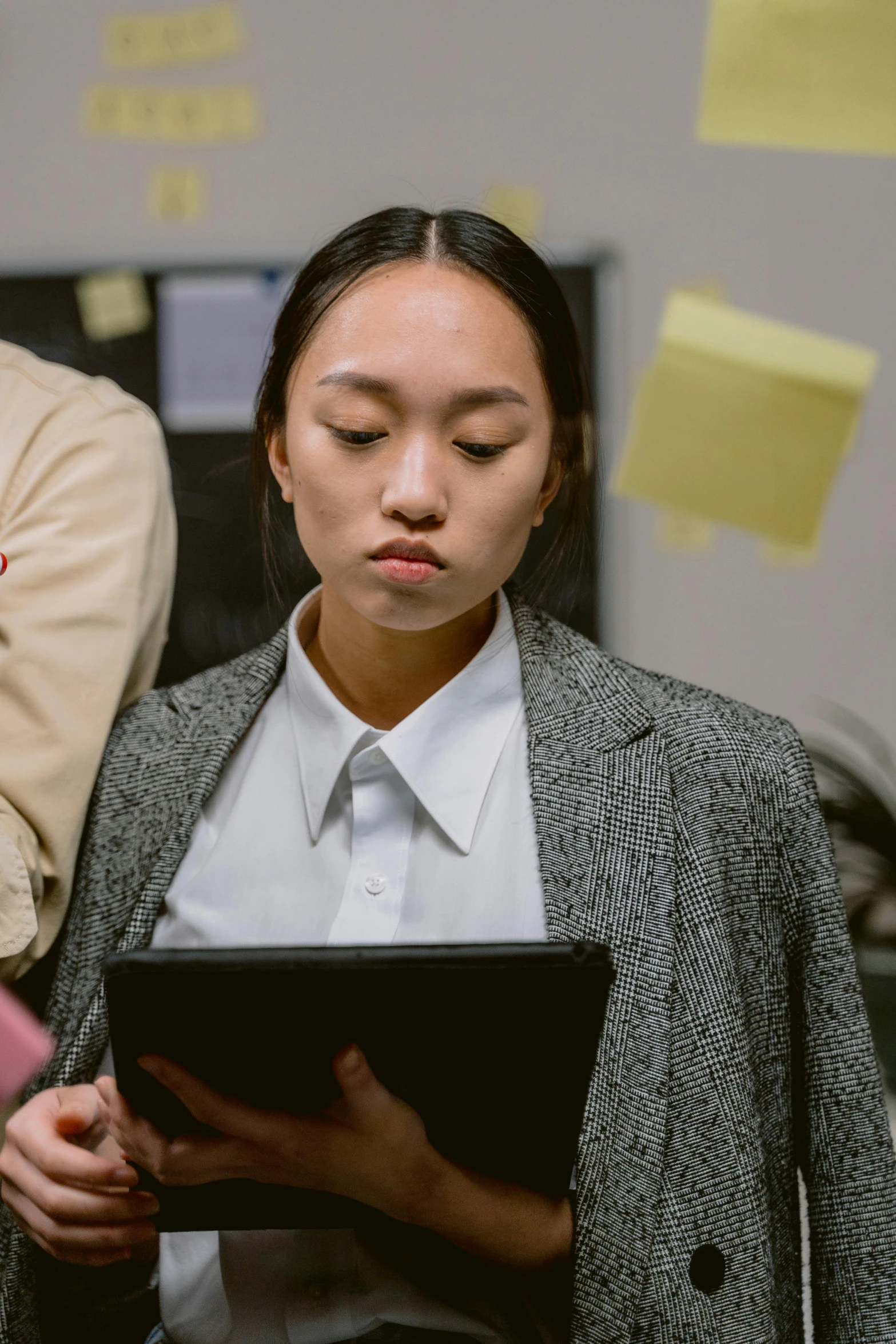 a man and woman looking at a tablet computer, trending on pexels, realism, asian woman, standing in class, looking serious, inspect in inventory image