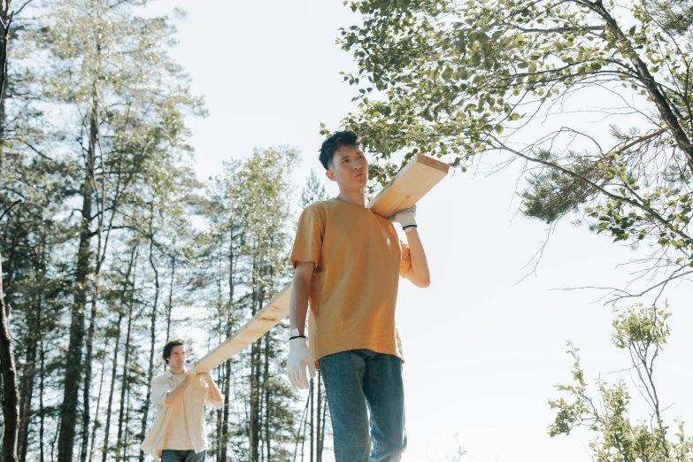 a man standing next to a boy on a skateboard, pexels contest winner, visual art, forest picnic, very long arms, avatar image, low - angle shot