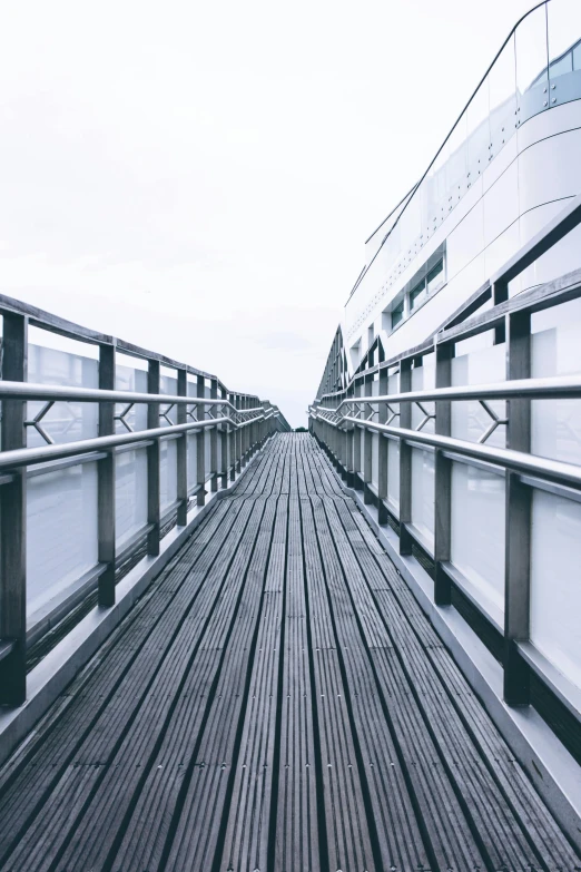 a black and white photo of a bridge, unsplash, minimalism, standing on a ship deck, square lines, shades of blue and grey, catwalk