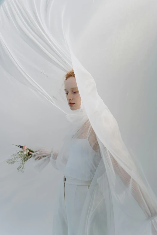 a woman in a white dress holding a bouquet, an album cover, inspired by Anna Füssli, funeral veil, a redheaded young woman, ignant, wearing organza gown