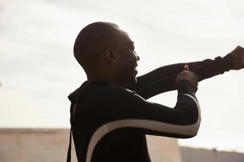 a man in a wet suit holding a surfboard, by Barthélemy Menn, happening, supportive, kano), 4k movie still