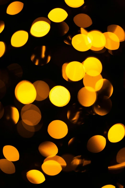 a bunch of yellow lights in the dark, an album cover, pexels, dots abstract, christmas lights, soft light - n 9, dynamic closeup