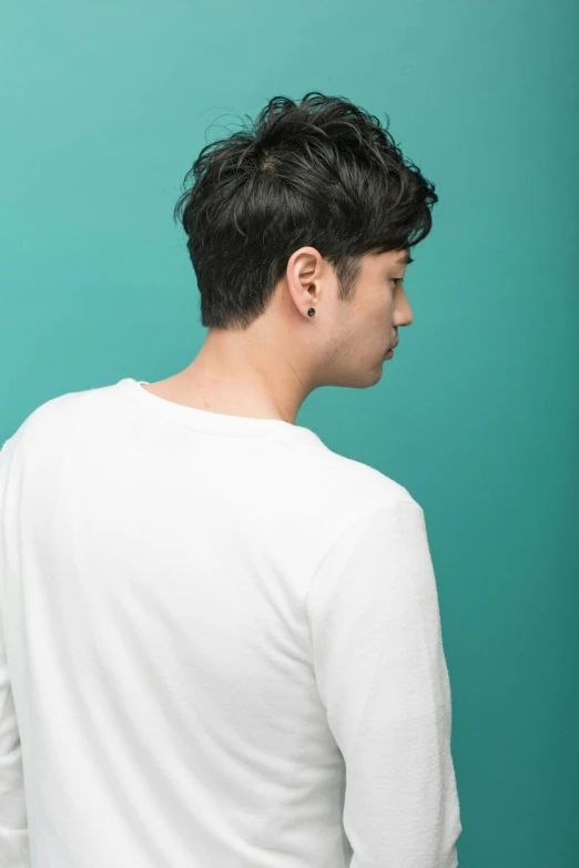 a couple of young men standing next to each other, inspired by Joong Keun Lee, trending on pexels, back of the hair, solid background, jc park, profile shot