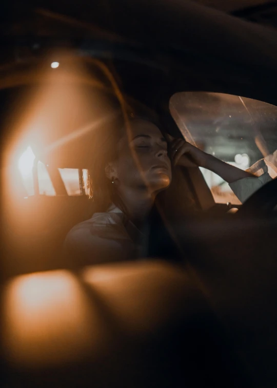 a man sitting in the driver's seat of a car, a picture, inspired by Elsa Bleda, pexels contest winner, happening, elle fanning at night, magdalena radziej, profile image, hiding