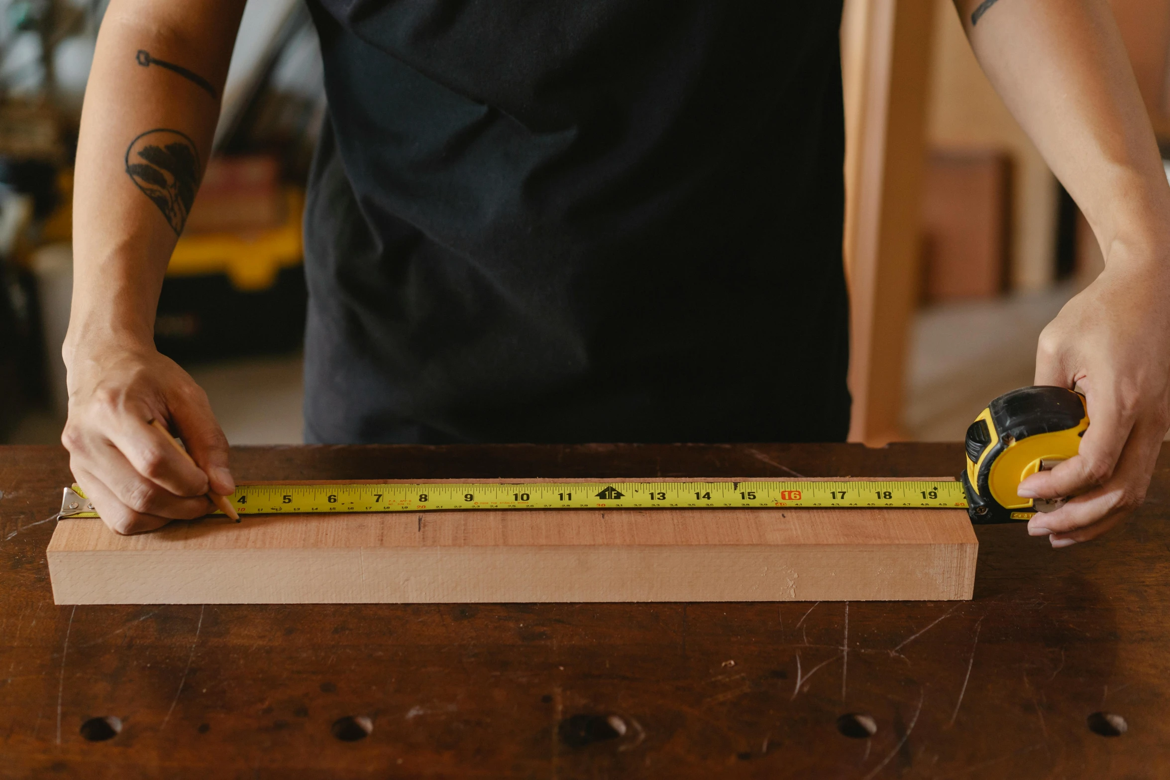 a man measuring a piece of wood with a tape, pexels contest winner, banner, alana fletcher, workbench, large tall