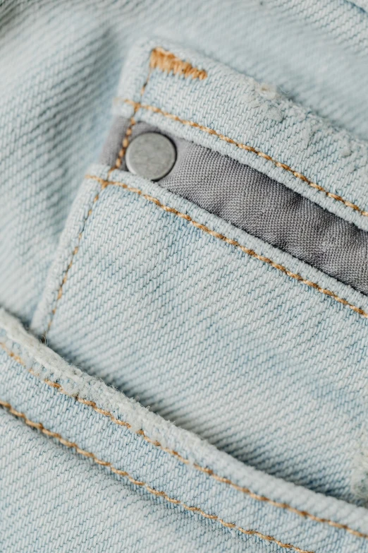 a close up of a pocket in a pair of jeans, trending on pexels, light grey mist, product view, white neon wash, highly_detailded