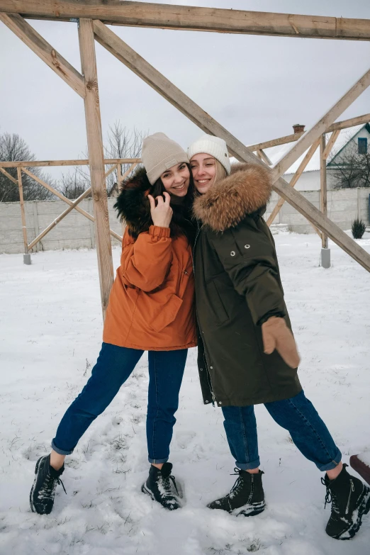 two women standing next to each other in the snow, a picture, trending on pexels, russian girlfriend, full body in frame, good times, commercial photo