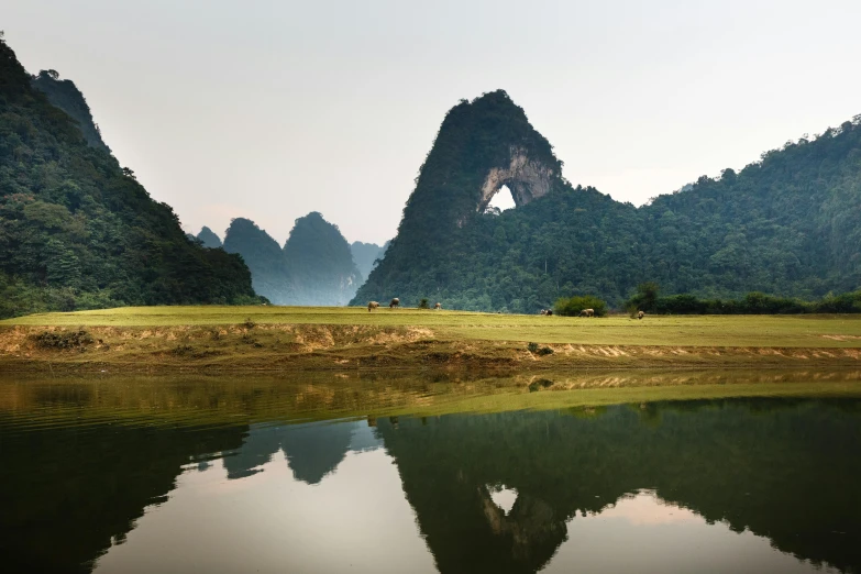 a body of water with mountains in the background, inspired by Steve McCurry, massive arch, in style of lam manh, the see horse valley, 2 0 2 2 photo