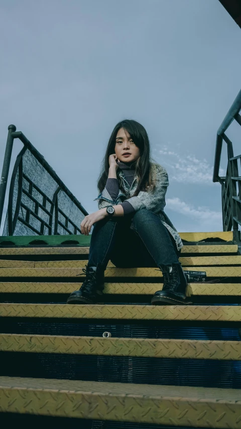 a woman sitting on some stairs talking on a cell phone, an album cover, inspired by Ni Yuanlu, pexels contest winner, maisie williams, heise-lian yan fang, confident pose, square