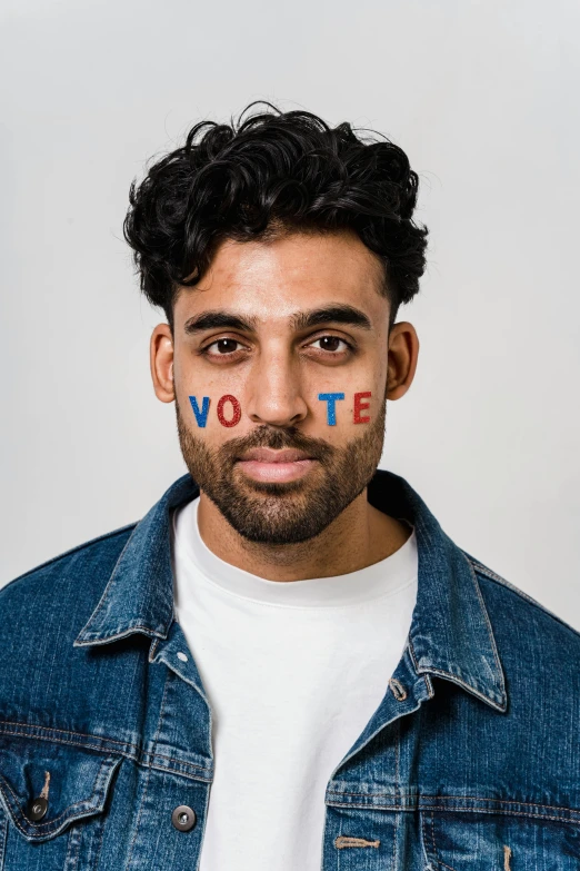 a man with the word vote painted on his face, a colorized photo, inspired by Ismail Gulgee, trending on pexels, renaissance, a portrait of rahul kohli, ashteroth, promo image, paul davey