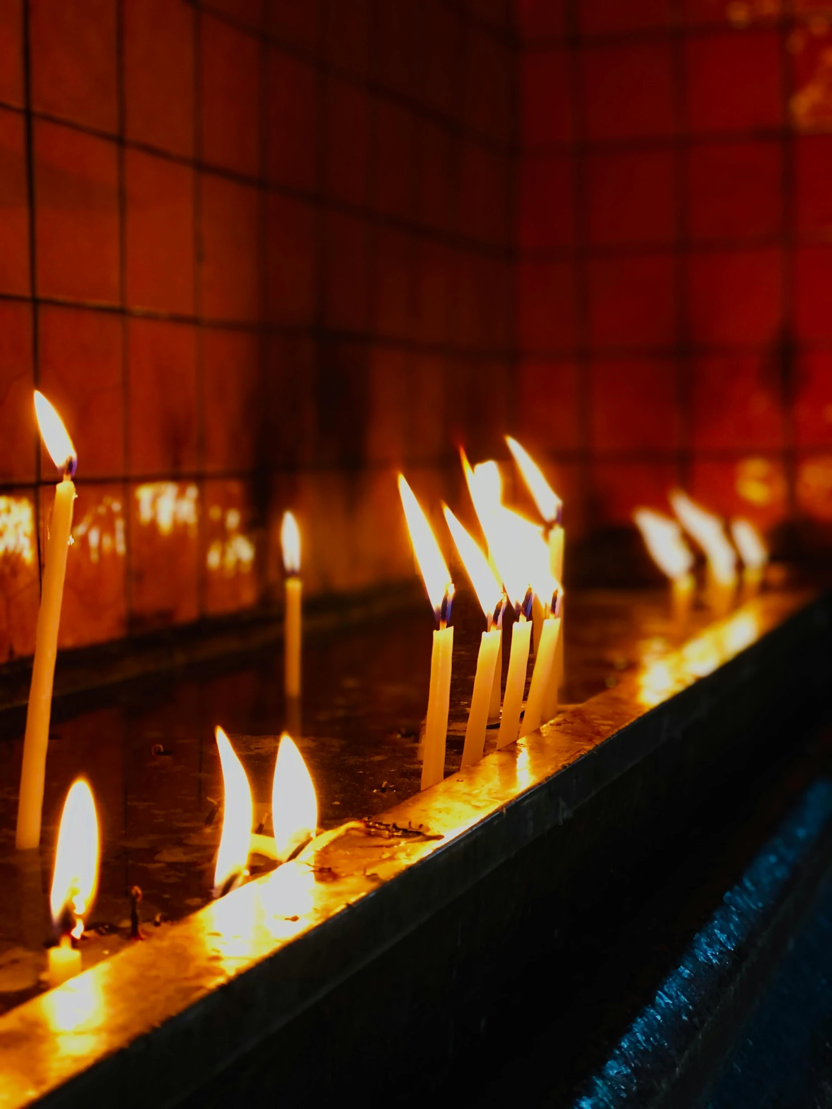 a row of lit candles in a church, an album cover, inspired by Elsa Bleda, pexels, profile image, buddhist, instagram photo, leaking