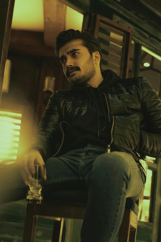 a man sitting on top of a wooden chair, an album cover, pexels contest winner, dau-al-set, wearing leather jacket, saadane afif, still frame from a movie, sayem reza