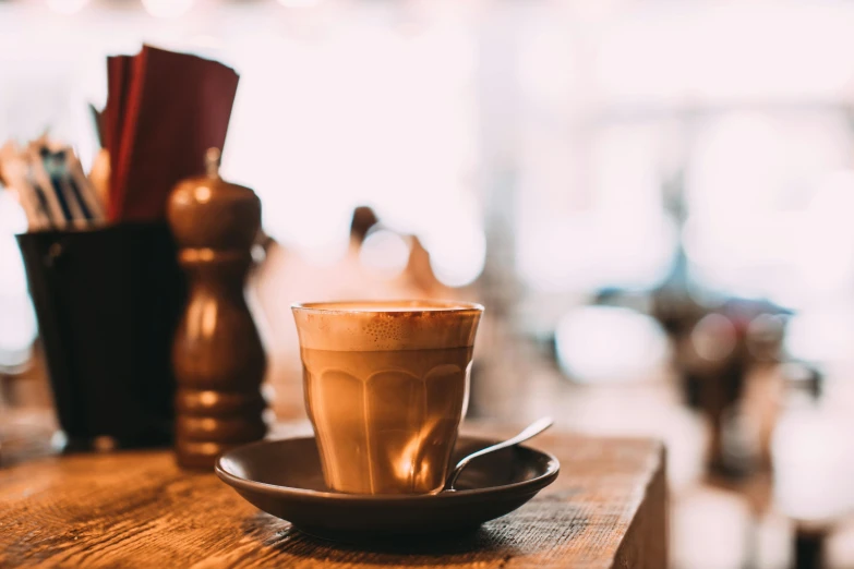 a cup of coffee sitting on top of a wooden table, trending on unsplash, romanticism, aussie baristas, avatar image, profile image, thumbnail