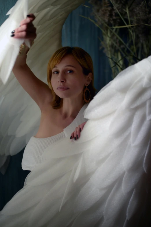 a woman in a white dress holding a white swan, an album cover, inspired by Leila Faithfull, pexels contest winner, zoe kazan, with two pairs of wings, maxim sukharev, perfectly lit. movie still