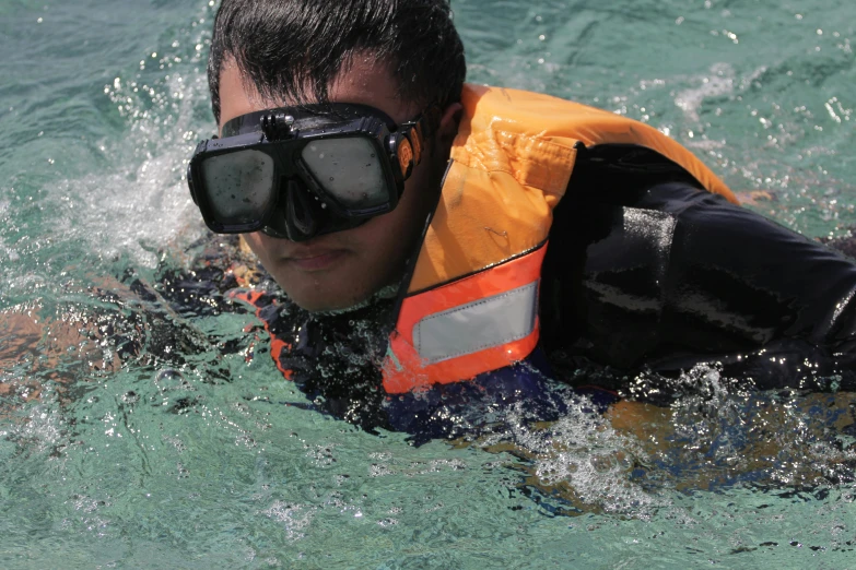 a man in a life jacket and goggles in the water, avatar image, thumbnail, head down, zoom shot