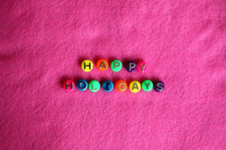 the word happy holidays spelled in colorful beads, pexels, hot pink, polymer clay, lgbt, amanda clarke