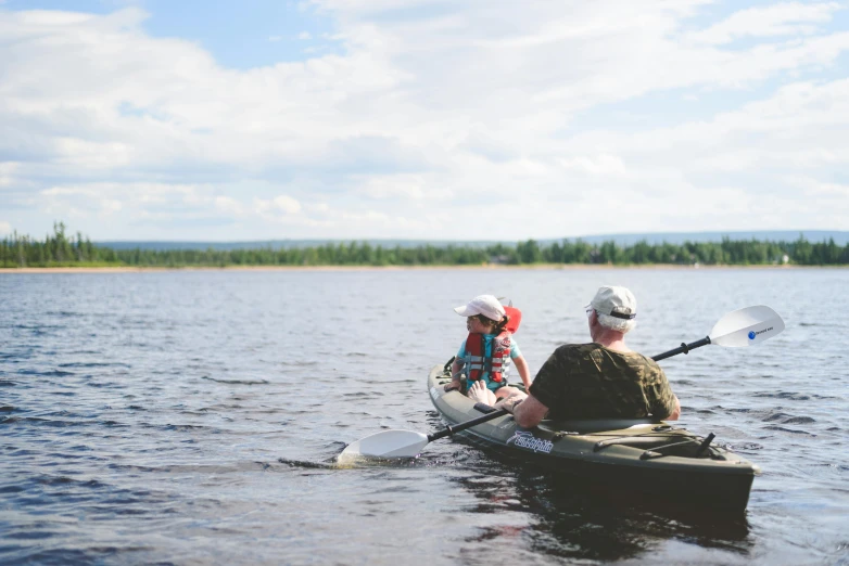 a couple of people riding on the back of a kayak, by Jaakko Mattila, unsplash, hurufiyya, 2 years old, lapland, low quality photo, maintenance