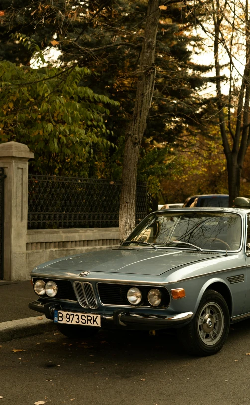 a car is parked on the side of the road, by Carlo Martini, unsplash, renaissance, bmw, tehran, old style photo, autum