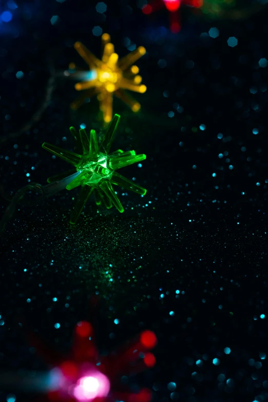 a bunch of lights that are on a table, a microscopic photo, by David Donaldson, pexels, spiky, ornament, starfield, green